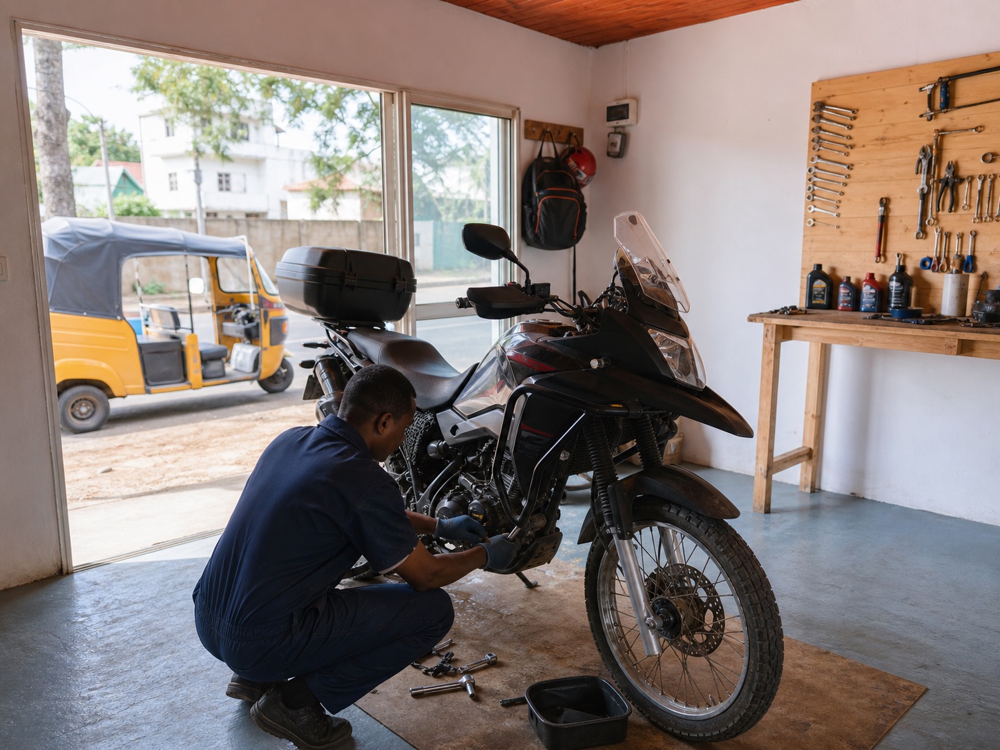 Mécanicien Nosy Biker en tenue bleue travaillant sur une moto dans l'atelier